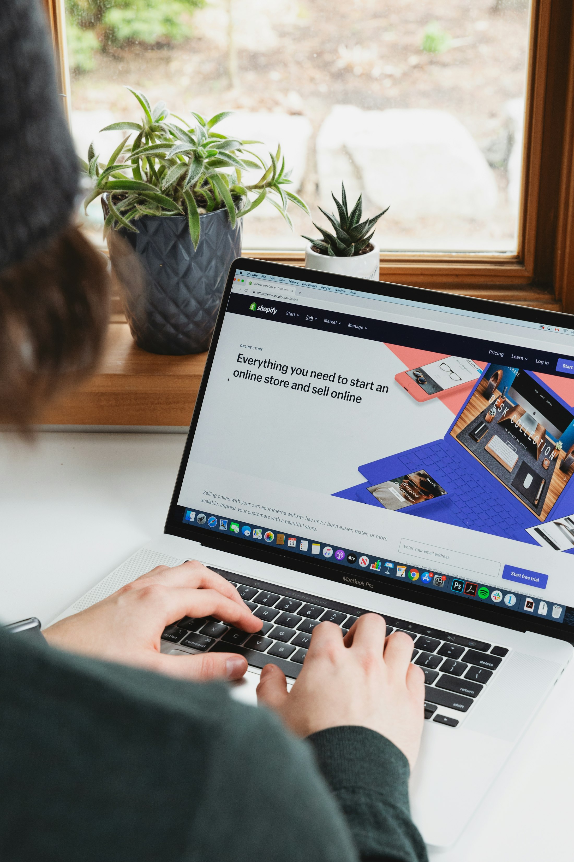 A person working on a laptop with an ecommerce website open