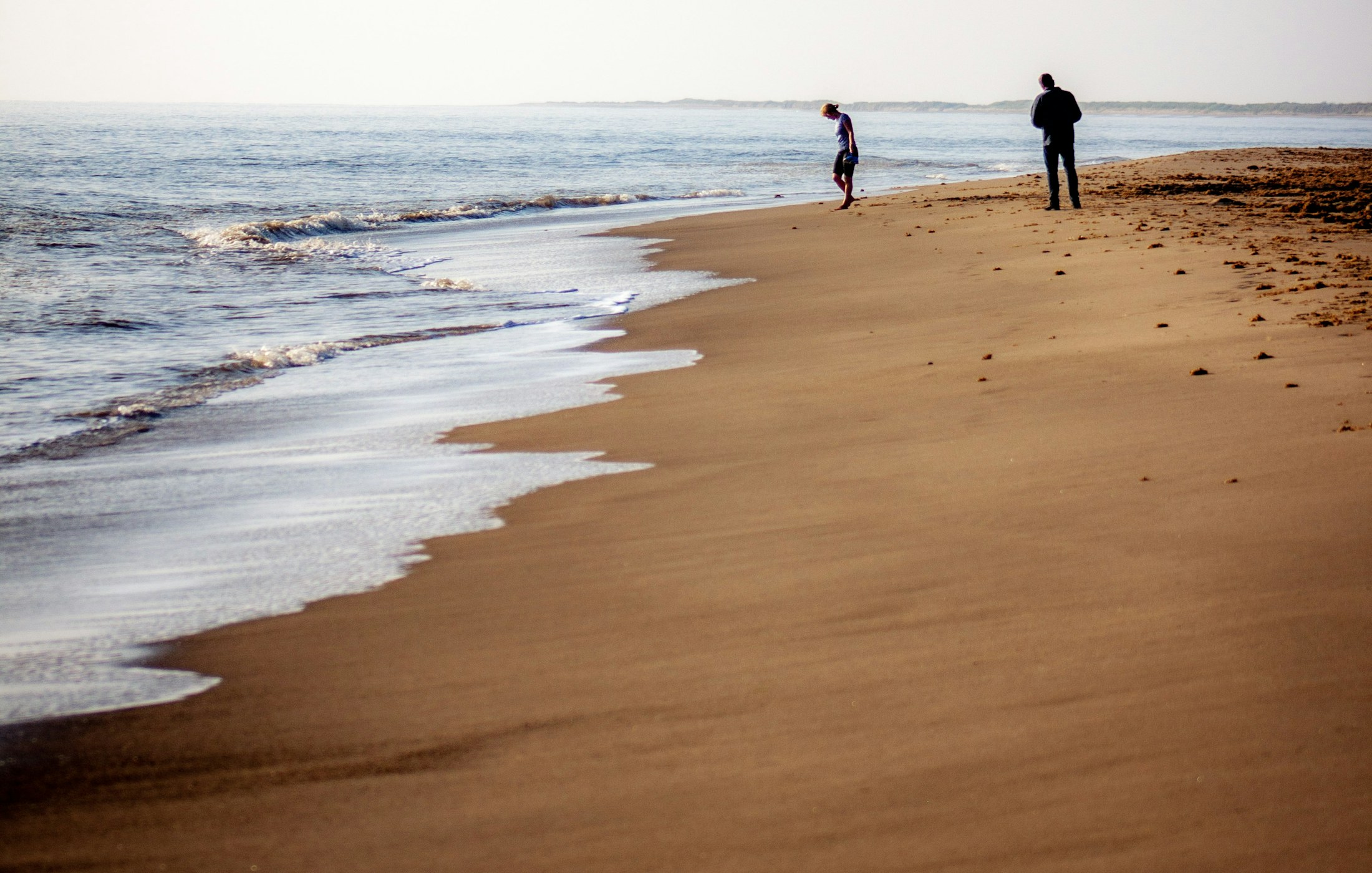 People standing on Skegness beach in Lincolnshire
